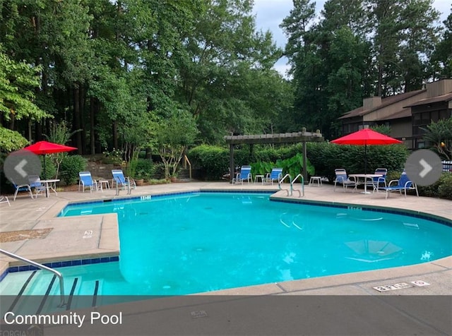 pool with a pergola and a patio