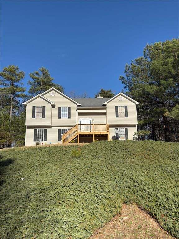 back of house featuring a wooden deck