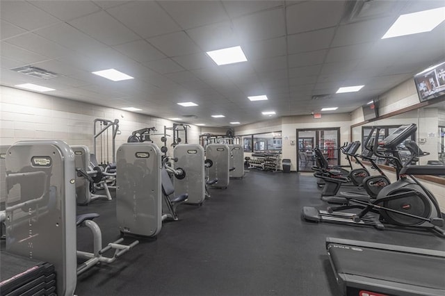 exercise room featuring a paneled ceiling and visible vents