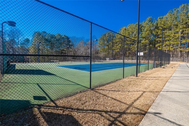 view of sport court with fence