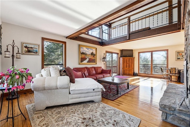 8145 Stone Hill Rd, Cumming, GA 30028 - living area with healthy amount of natural light, wood finished floors, and a towering ceiling
