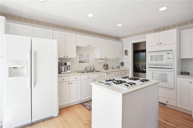 8145 Stone Hill Rd, Cumming, GA 30028 - kitchen featuring white appliances, a sink, white cabinets, light wood-style floors, and recessed lighting
