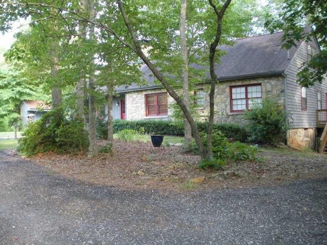 8145 Stone Hill Rd, Cumming, GA 30028 - view of front of home with stone siding and a shingled roof