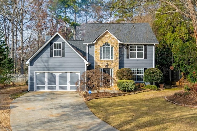 view of front of property with a garage and a front lawn