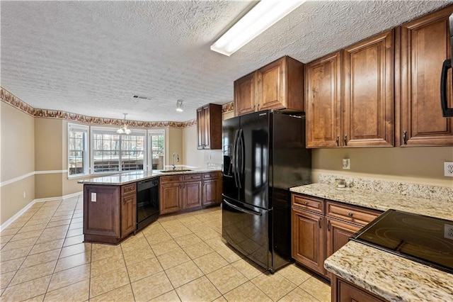 kitchen with kitchen peninsula, a textured ceiling, decorative light fixtures, black appliances, and sink