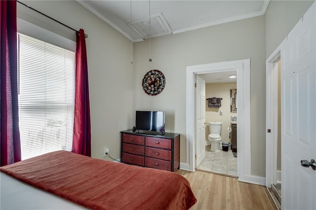 bedroom featuring attic access, multiple windows, crown molding, and light wood-type flooring