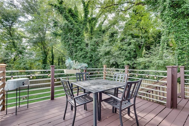 wooden terrace featuring outdoor dining space