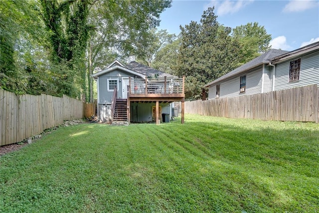 view of yard with a wooden deck, stairs, and a fenced backyard