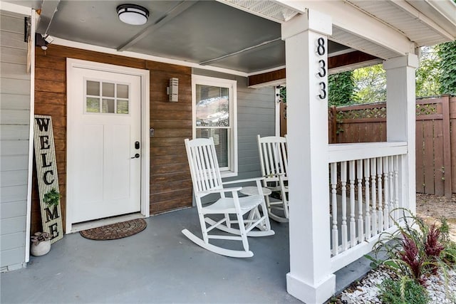 view of patio / terrace with a porch and fence