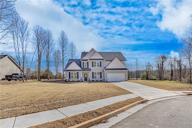 view of front of property featuring board and batten siding, concrete driveway, a front yard, a garage, and stone siding