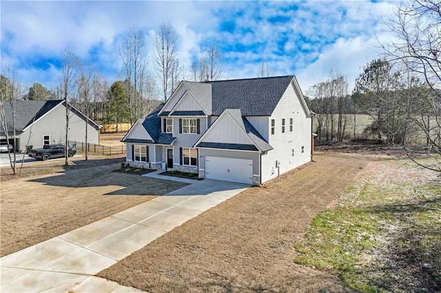 view of front facade featuring board and batten siding, a shingled roof, an attached garage, a front lawn, and driveway