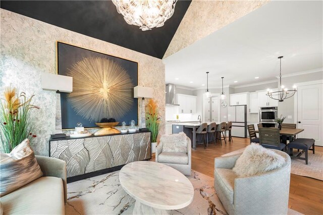 living area with vaulted ceiling and an inviting chandelier