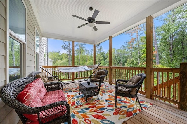 sunroom / solarium featuring a wealth of natural light and a ceiling fan