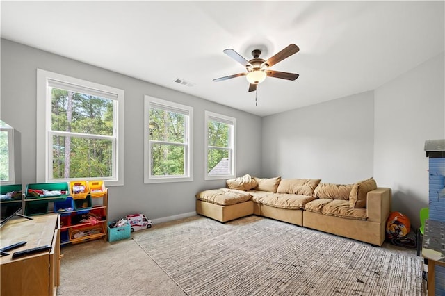 playroom featuring light carpet and ceiling fan