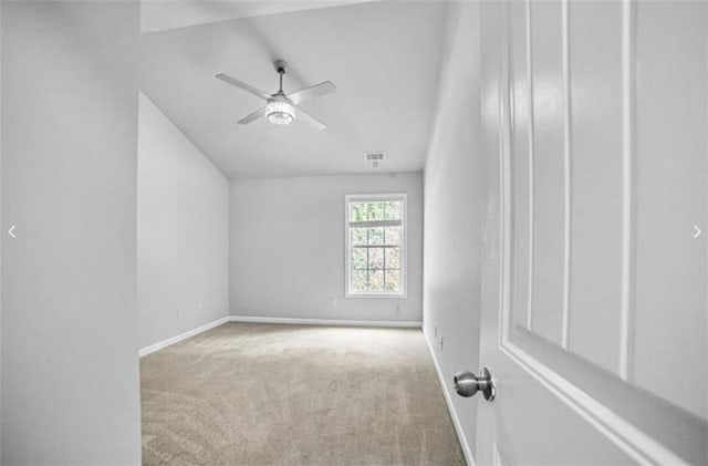 interior space with ceiling fan and light colored carpet