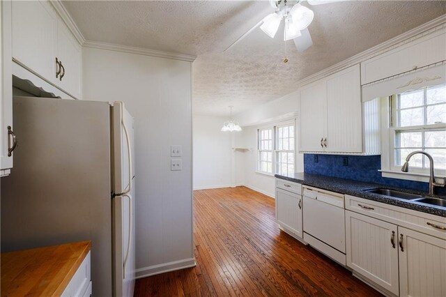 unfurnished living room with a brick fireplace and dark carpet