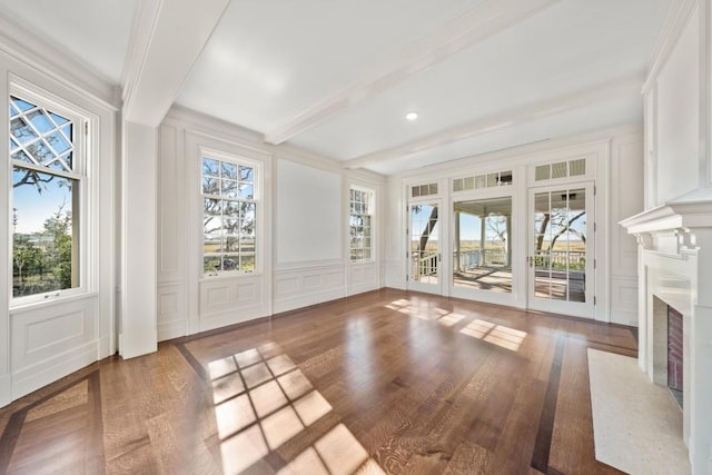 interior space with a fireplace, plenty of natural light, and hardwood / wood-style flooring