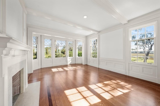 unfurnished sunroom featuring beam ceiling