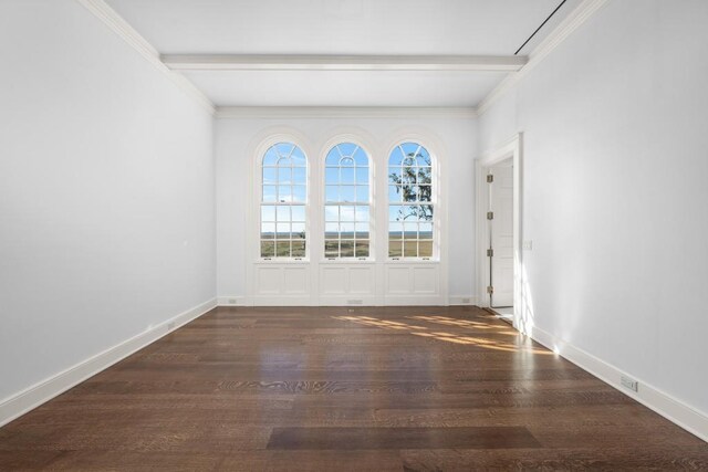 unfurnished room featuring beamed ceiling, dark hardwood / wood-style floors, and ornamental molding