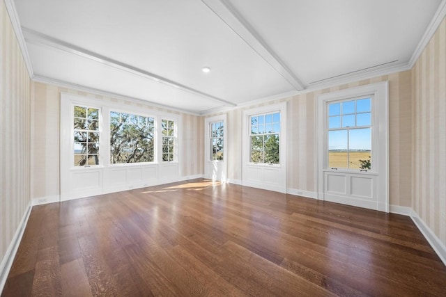 interior space with a wealth of natural light, dark hardwood / wood-style flooring, and crown molding