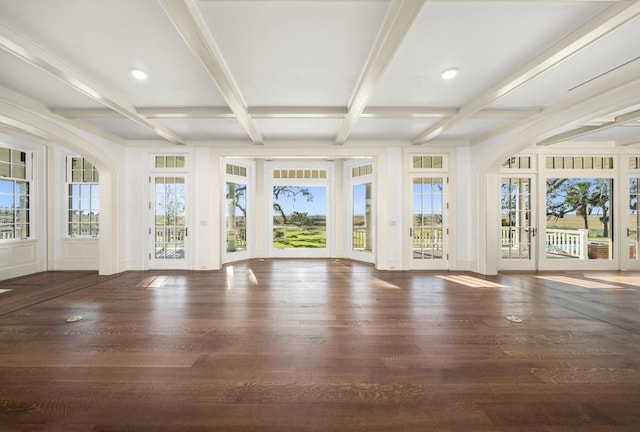 unfurnished sunroom with plenty of natural light and beamed ceiling