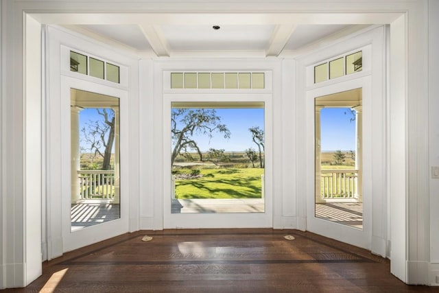 doorway to outside with beamed ceiling and dark hardwood / wood-style floors