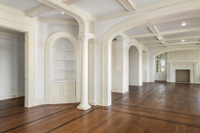 interior space with coffered ceiling, crown molding, built in shelves, beamed ceiling, and dark hardwood / wood-style flooring