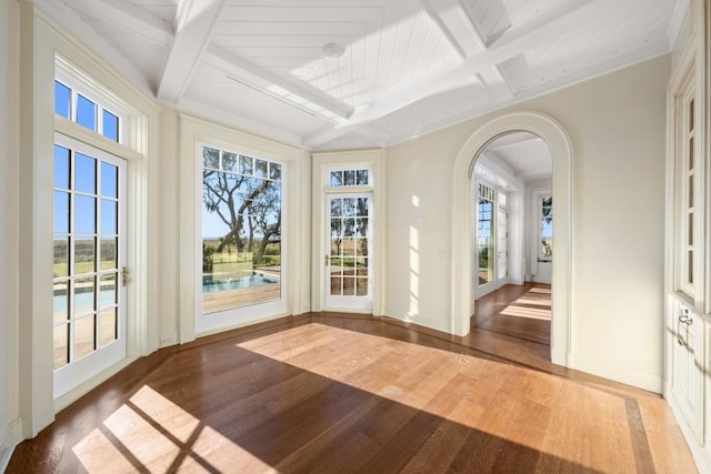 unfurnished sunroom with beamed ceiling