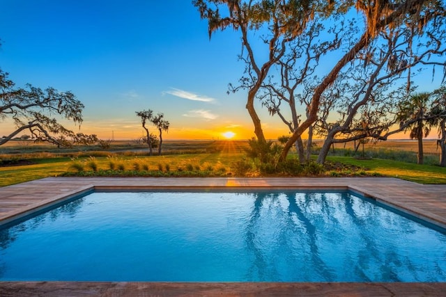 view of pool at dusk