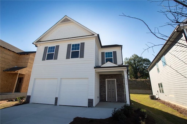 view of front of house with central AC and a garage