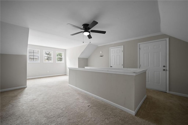 additional living space featuring a ceiling fan, lofted ceiling, carpet flooring, and baseboards