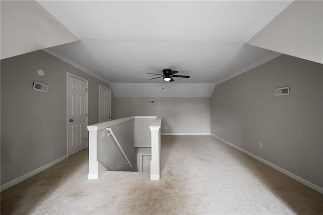 additional living space with vaulted ceiling, carpet floors, and visible vents