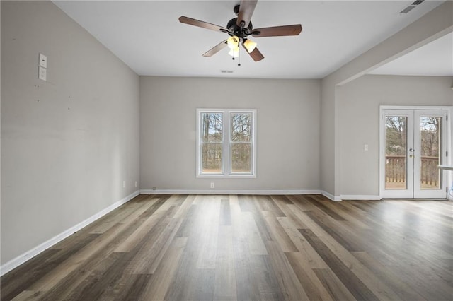 spare room featuring french doors, visible vents, plenty of natural light, and baseboards