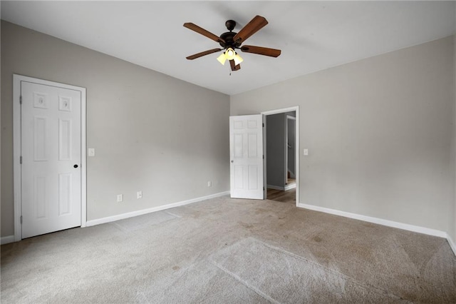 unfurnished bedroom with carpet floors, ceiling fan, and baseboards