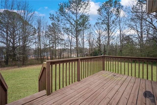 wooden terrace featuring a lawn