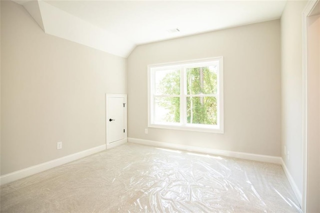 spare room with vaulted ceiling