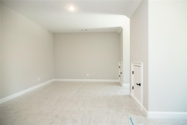 unfurnished room featuring light colored carpet