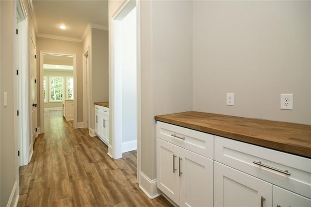 hallway featuring light hardwood / wood-style flooring and ornamental molding