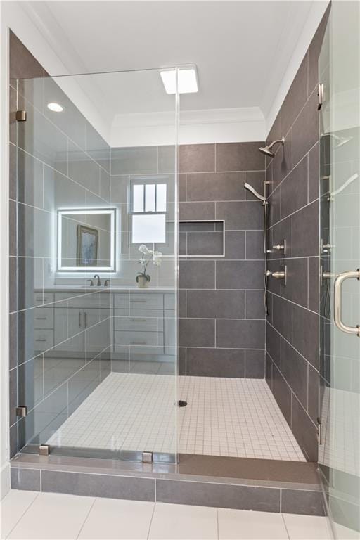 bathroom featuring a shower with shower door and ornamental molding