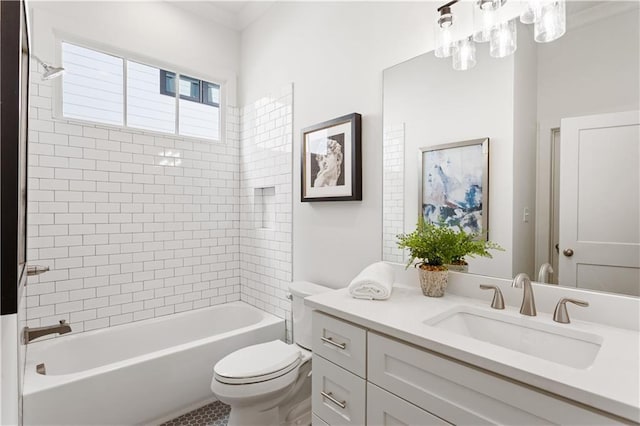 full bathroom with tiled shower / bath, vanity, and toilet