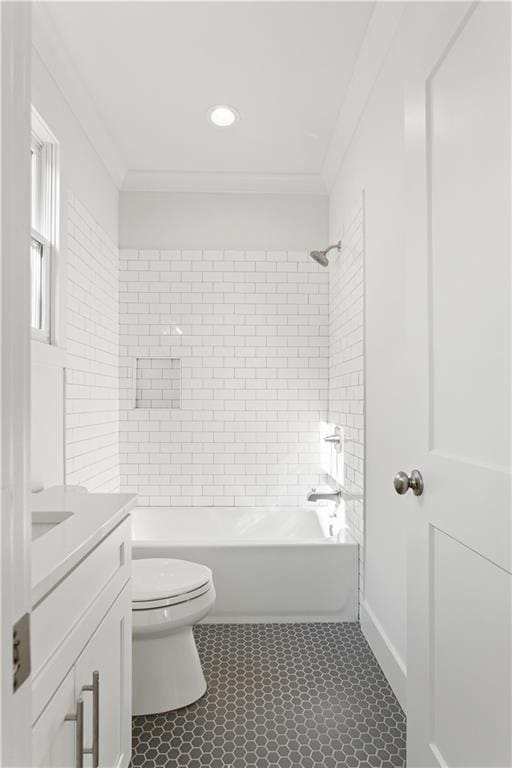 full bathroom featuring vanity, crown molding, tiled shower / bath combo, and toilet