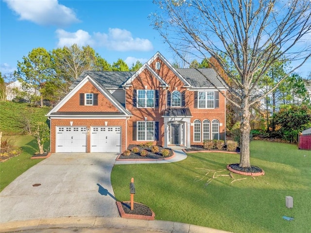 view of front of property with a front yard and a garage