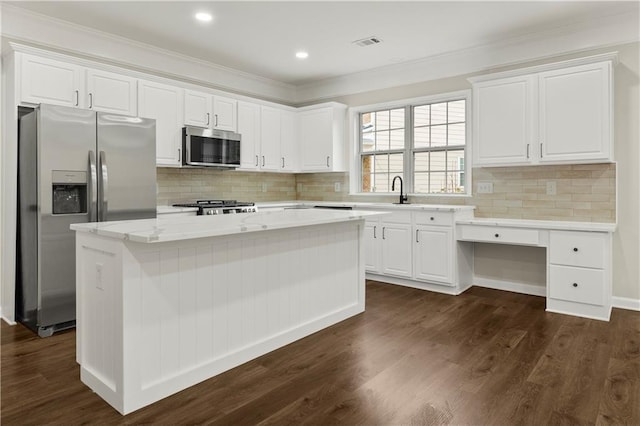 kitchen featuring white cabinetry, a kitchen island, dark wood-type flooring, and appliances with stainless steel finishes