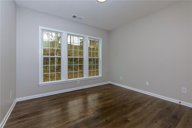 empty room featuring dark hardwood / wood-style flooring