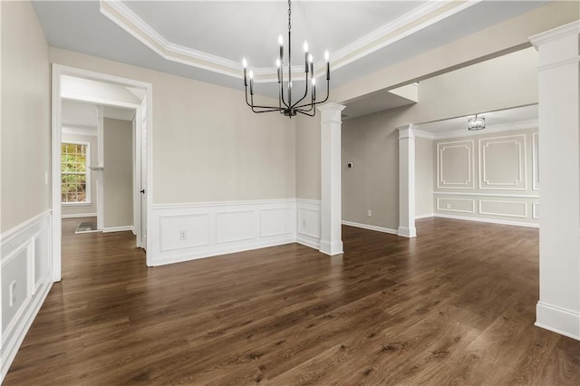 unfurnished dining area featuring a raised ceiling, an inviting chandelier, dark wood-type flooring, and crown molding