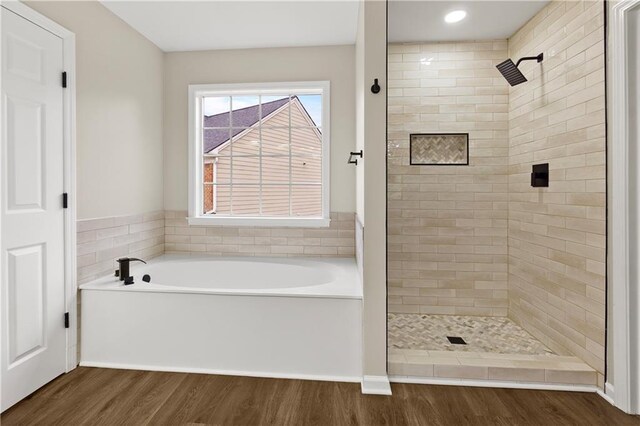 bathroom featuring hardwood / wood-style flooring and independent shower and bath