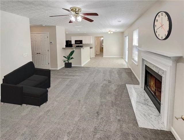 1371 Blazing Star Rd, Lawrenceville, GA 30045 - unfurnished living room featuring ceiling fan, a high end fireplace, light colored carpet, and a textured ceiling