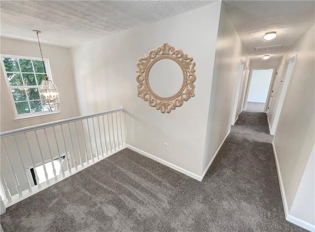 1371 Blazing Star Rd, Lawrenceville, GA 30045 - corridor with dark colored carpet, a chandelier, and a textured ceiling