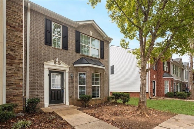 view of property featuring brick siding