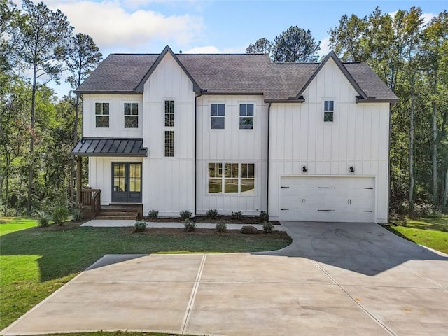 modern inspired farmhouse with a garage and a front lawn